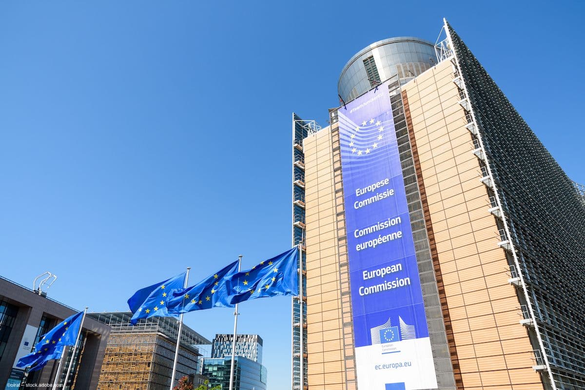 A large vertical banner, indicating the headquarters of the European Commission, hanging on the southern wing of the Berlaymont building. Image credit: ©olrat – stock.adobe.com