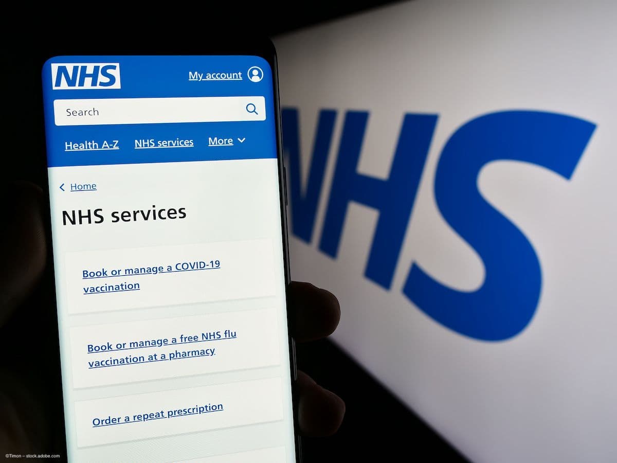 A phone and a computer with the NHS website pulled up. The webpage on the phone says "NHS Services." Image credit: ©Timon – stock.adobe.com