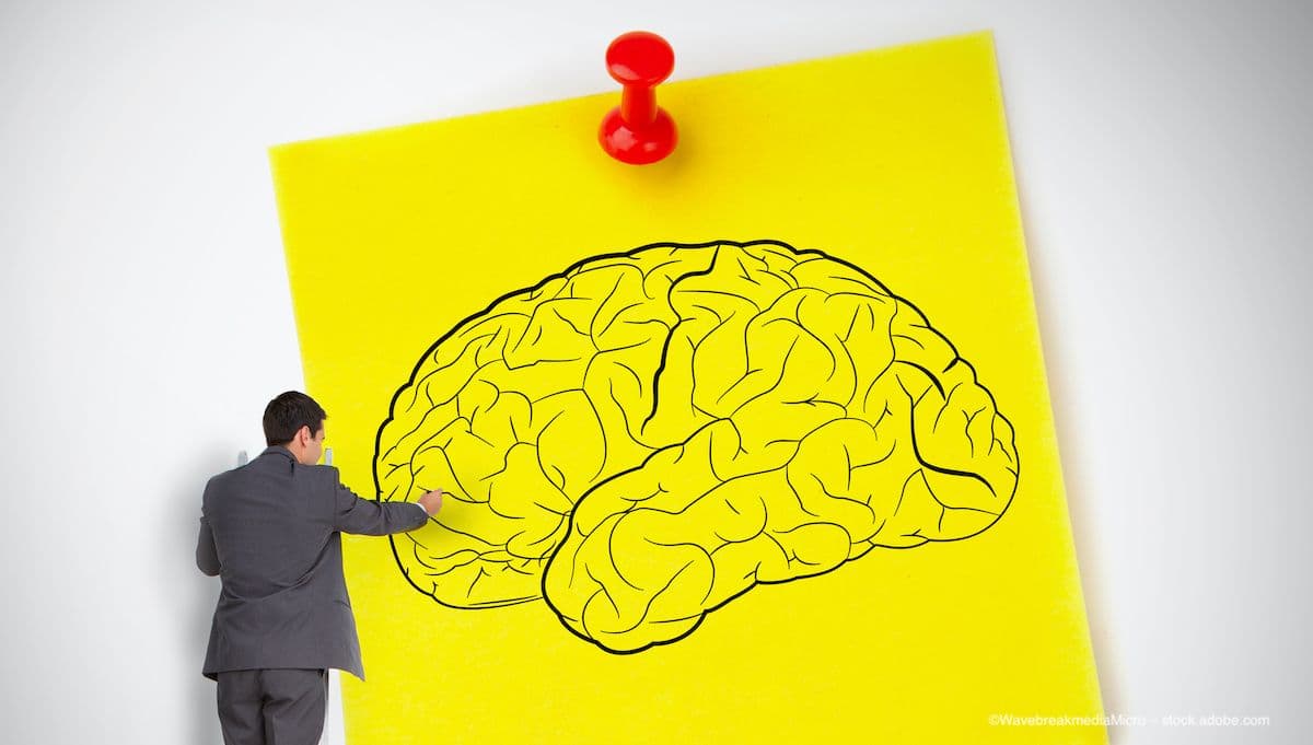 A businessman on a ladder draws a brain on a giant sticky note. Image credit: ©WavebreakmediaMicro – stock.adobe.com