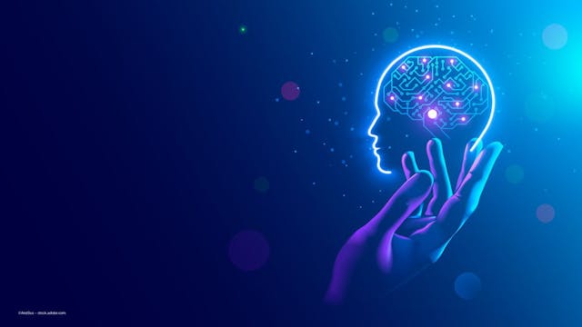 A hand and an icon of a brain with a computer chip in it, on a blue background. Image credit: ©AndSus – stock.adobe.com