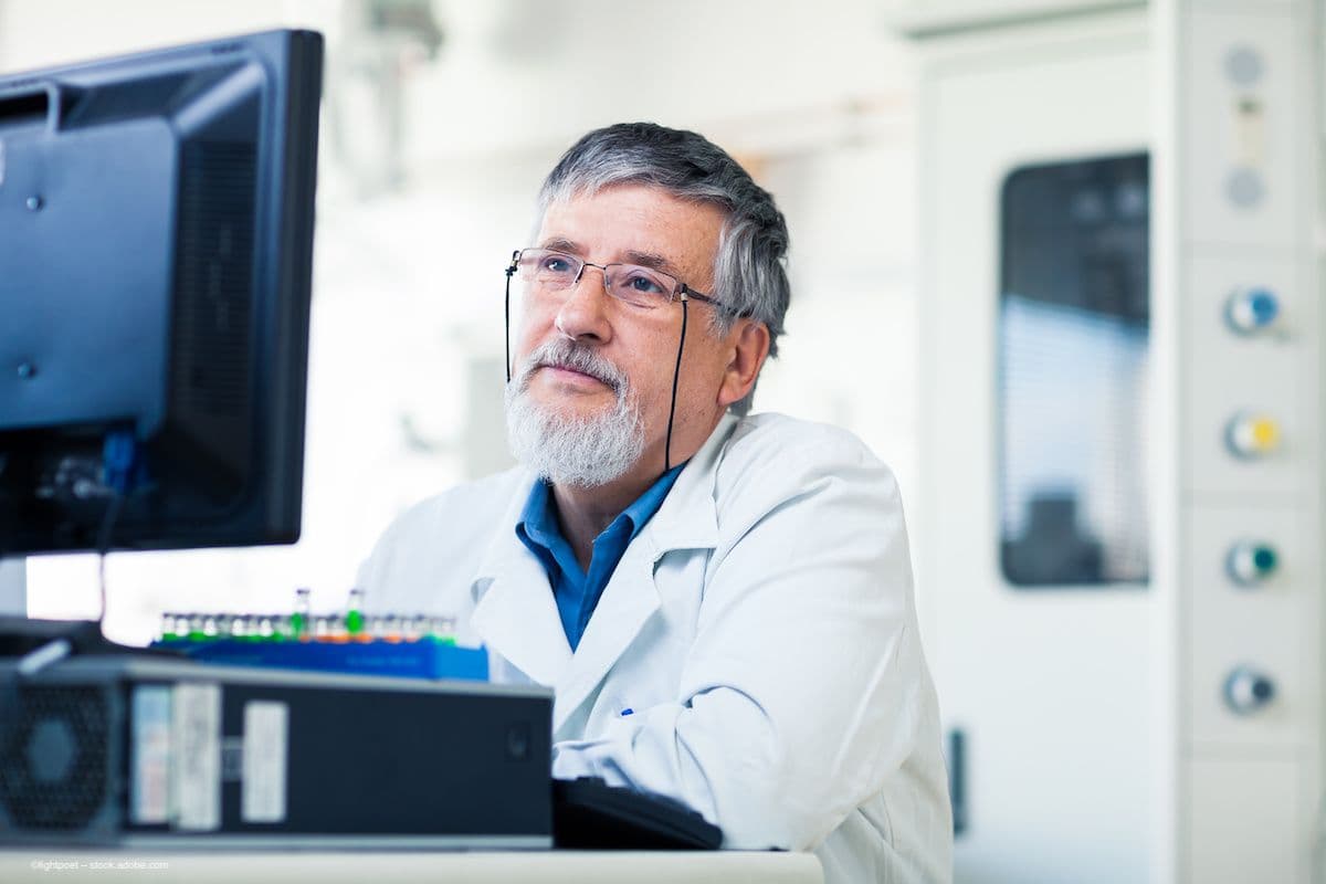 A scientist uses a computer in a lab setting. Image credit: ©lightpoet – stock.adobe.com