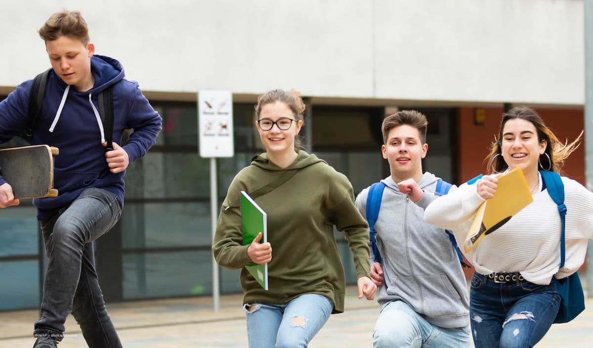 A group of children run outside. Image credit: ©JackF – stock.adobe.com