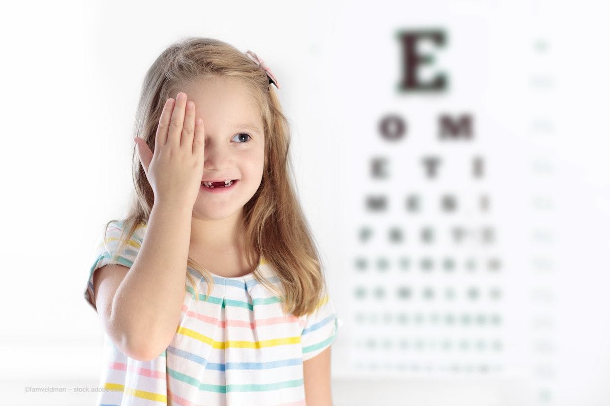 A young girl taking a vision exam covers one eye. Image credit: ©famveldman – stock.adobe.com