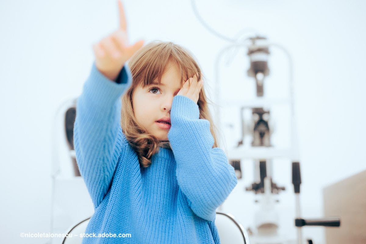 A child covers one eye and points at something in a doctor's office. Image credit: ©nicoletaionescu – stock.adobe.com