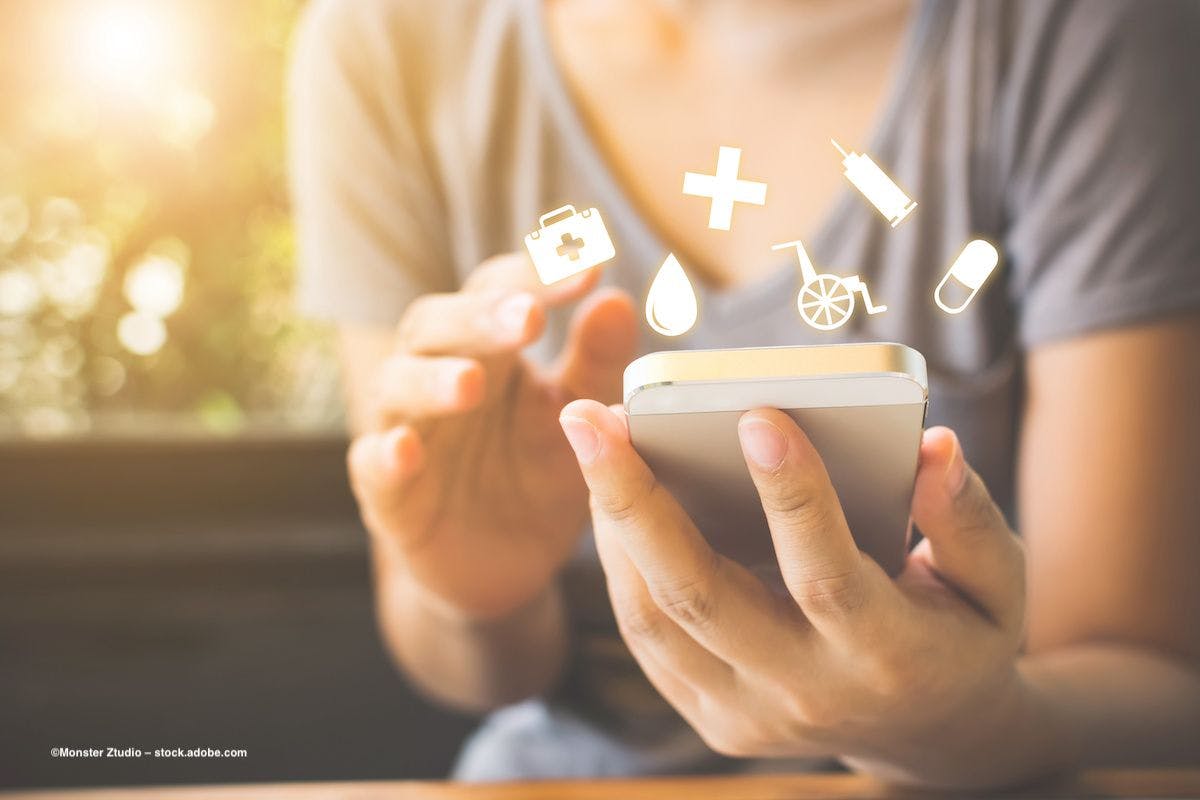 A person holds a phone in their hand. Above the phone, icons such as a cross, a pill, a wheelchair and a syringe indicate they are looking at health information. Image credit: ©Monster Ztudio – stock.adobe.com