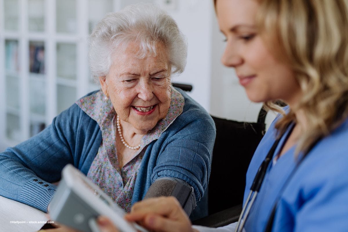 A home health aide assists a patient. Image credit: ©Halfpoint – stock.adobe.com