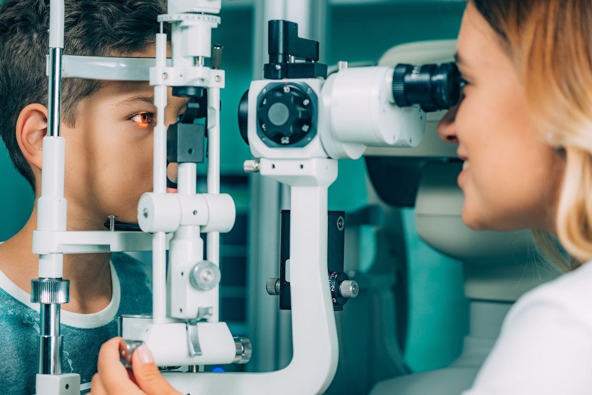 A child's eyes are examined by a physician using a slit lamp. Image credit: ©Microgen – stock.adobe.com