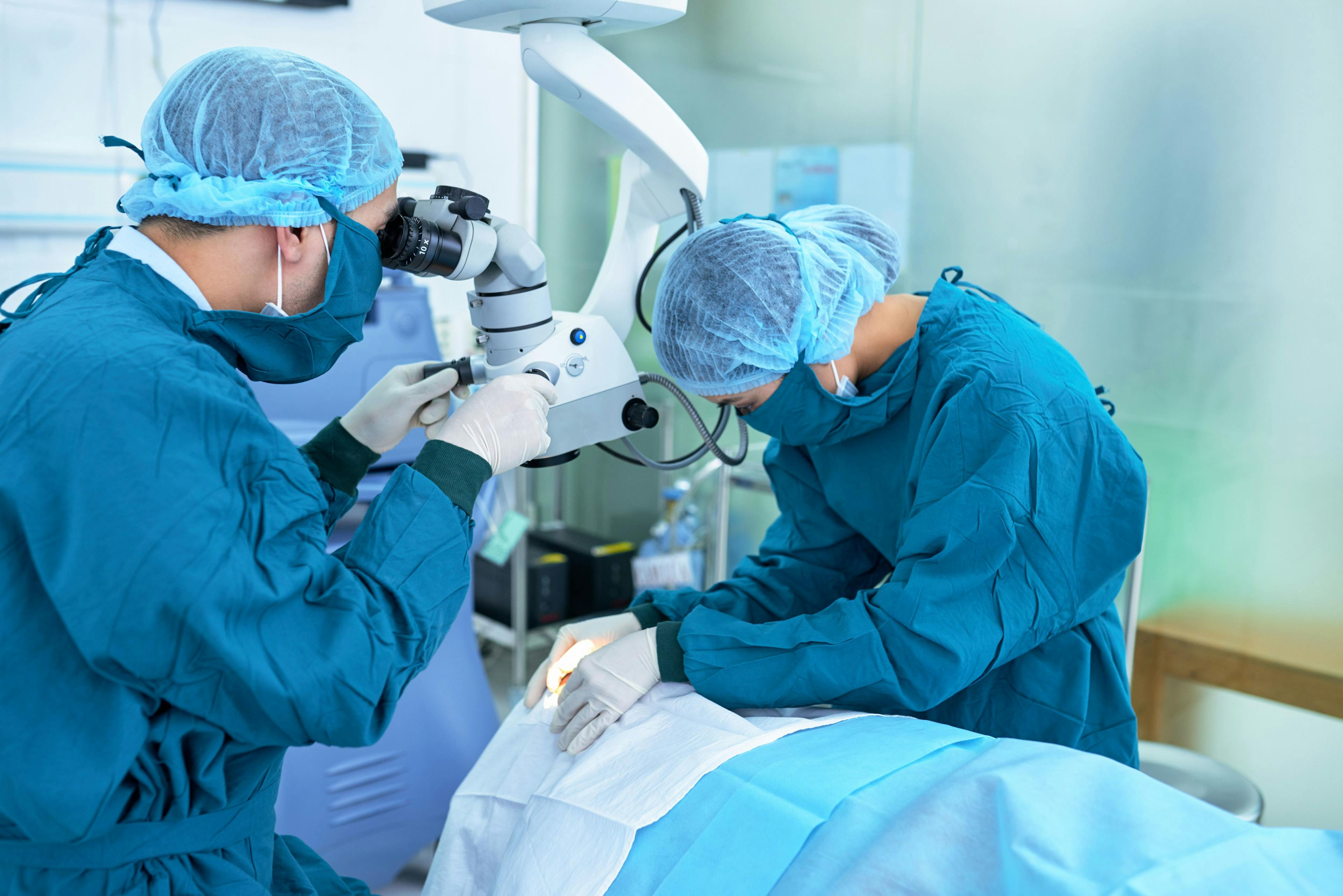 Doctors in operating room performing eye surgery