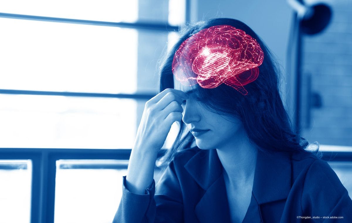 A woman pinches the bridge of her nose, indicating pain, and the image shows her brain lit up in red detail. Image credit: ©Thongden_studio – stock.adobe.com