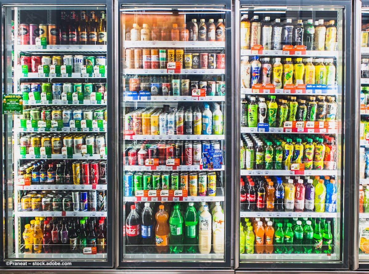 A refrigerated case of energy drinks at a grocery store. Image credit: ©Praneat – stock.adobe.com