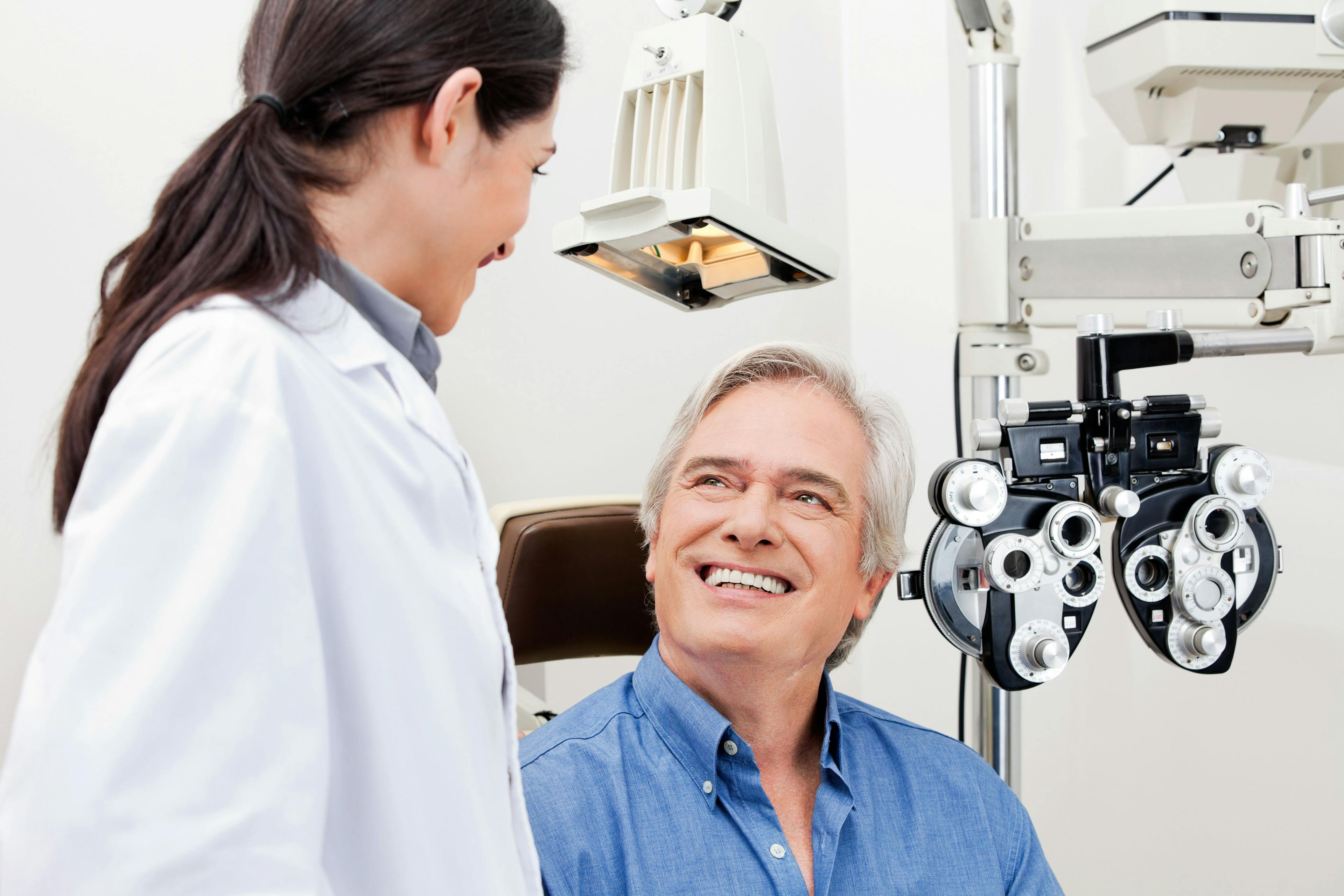 Ophthalmologist and male patient conferring